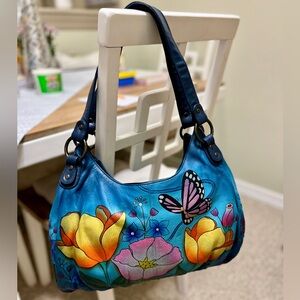 NEVER USED Anuschka blue purse with wallet, tote, coin bag, and phone case.